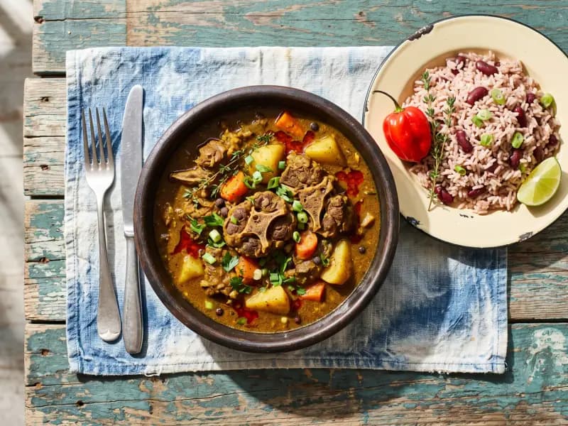 Curry Goat — shot from directly overhead: goat shoulder burned into curry powder and then cooked for two hours