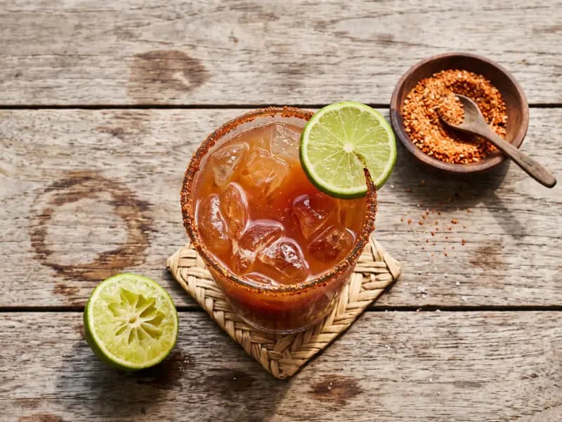 Michelada — shot from directly overhead: cold lager with lime