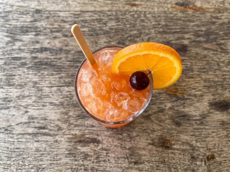 Rum Swizzle — shot from directly overhead, the table surface filling the frame