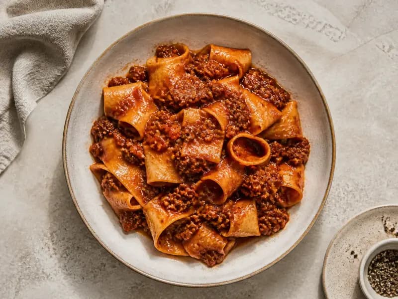 Slow-Cooked Beef Ragu — shot from directly overhead: coarse beef mince browned in batches then held at a bare simmer for three hours
