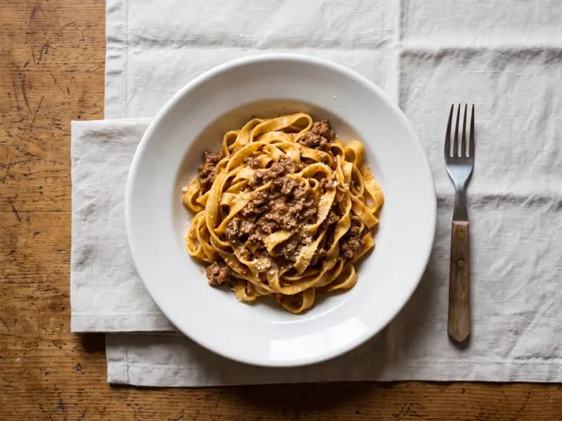 Tagliatelle al Ragù — shot from directly overhead: bolognese ragù cooked for three hours with milk and a little wine